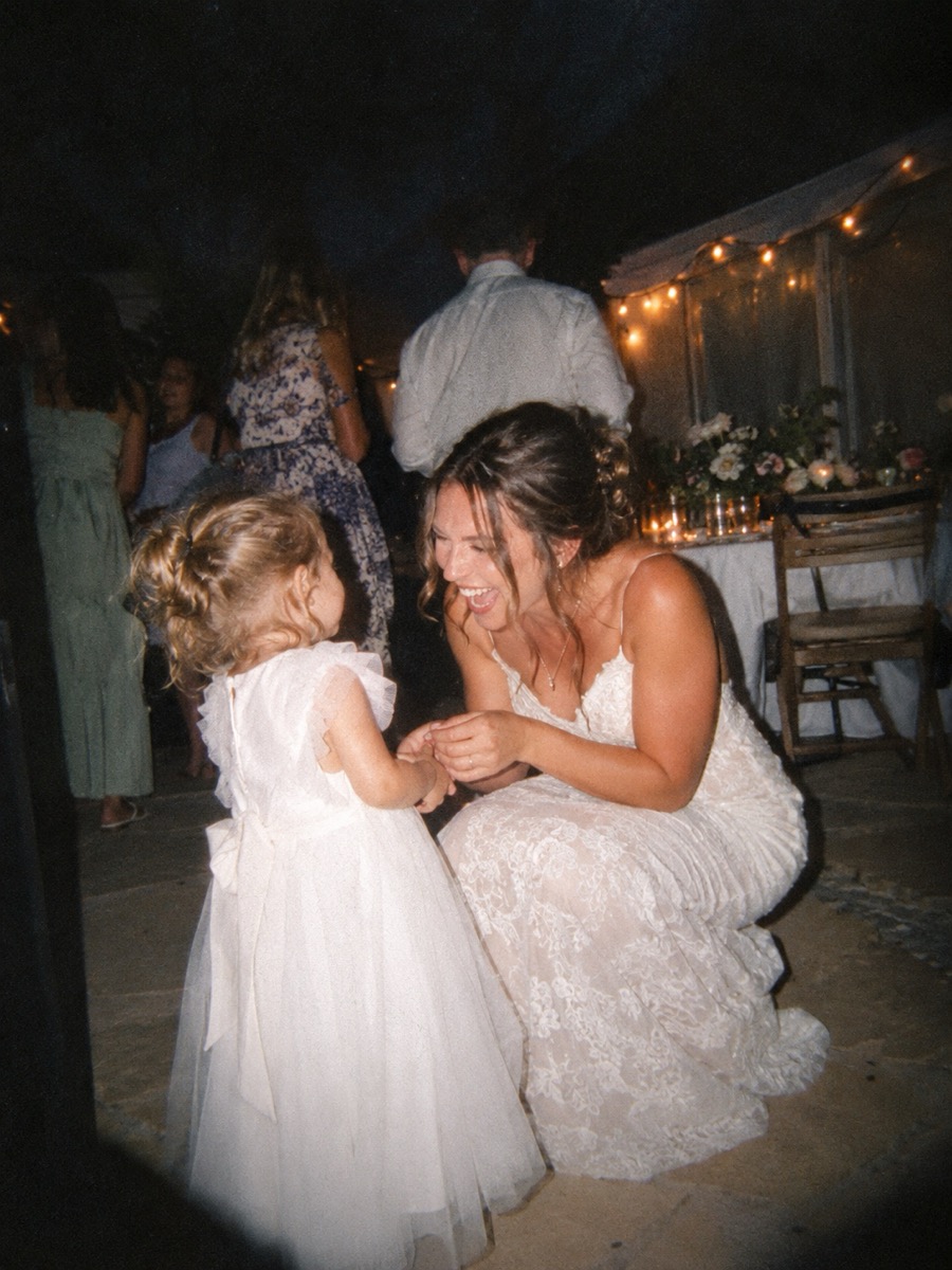 A bride laughing, lit by a warm flash